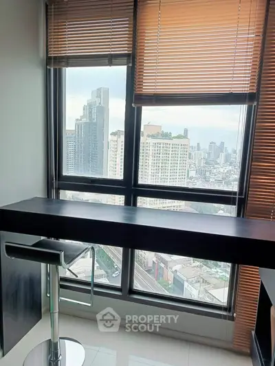 Modern high-rise apartment with stunning city view and sleek interior design.