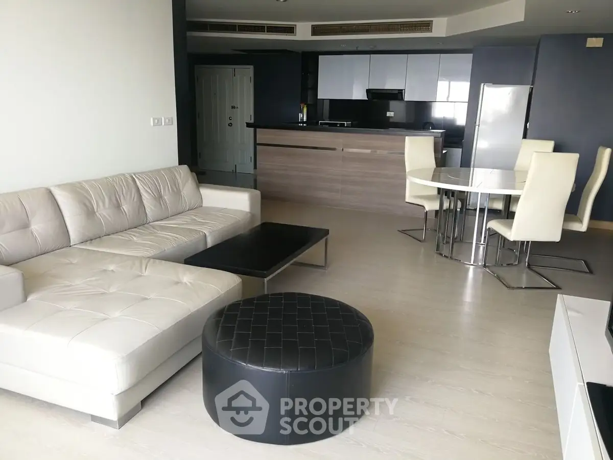 Spacious modern living room with open kitchen and stylish furniture