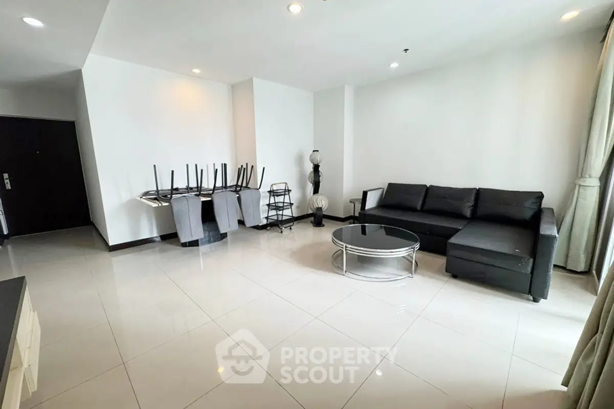 Spacious modern living room with sleek black sofa and elegant decor
