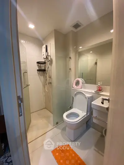 Modern bathroom with glass shower and sleek fixtures in a contemporary home.