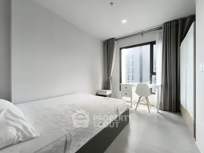Modern minimalist bedroom with large window and sleek furnishings