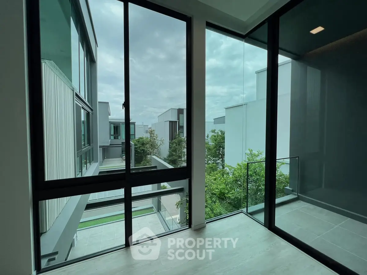 Modern corner unit with floor-to-ceiling windows offering a stunning view of contemporary architecture.