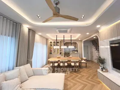 Luxurious open-plan living room with modern decor and elegant dining area