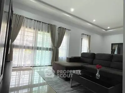 Spacious modern living room with elegant curtains and sleek furniture