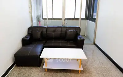 Modern living room with sleek black sofa and minimalist coffee table