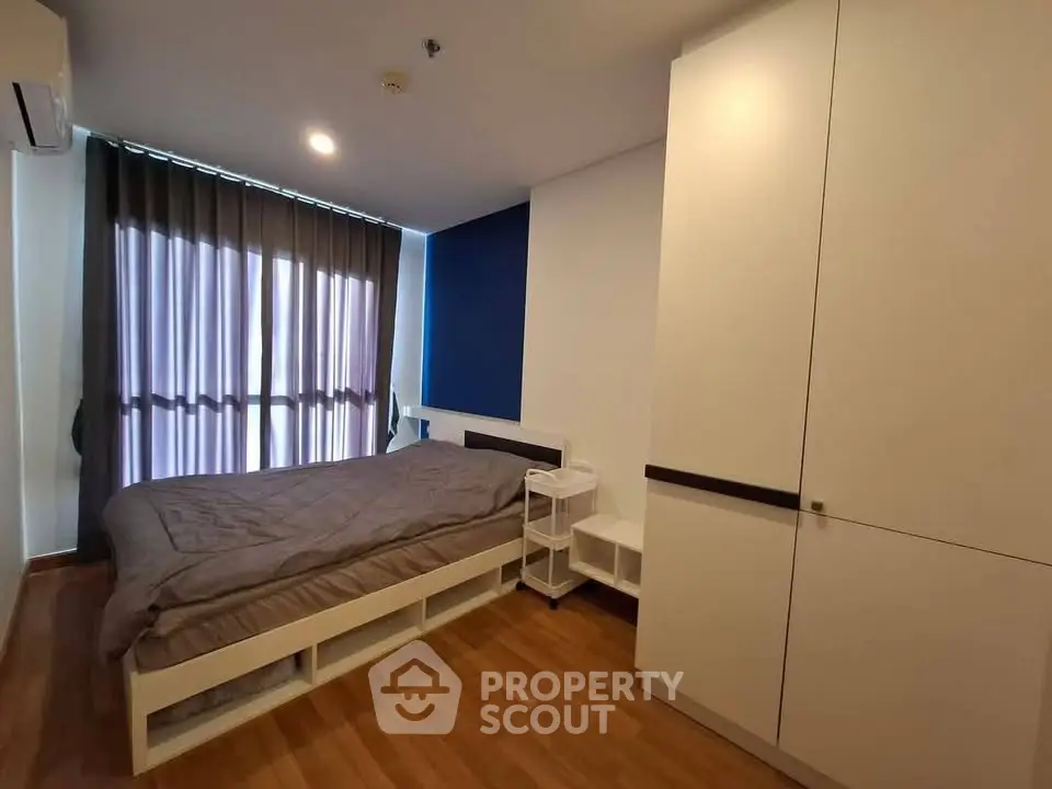 Modern bedroom with sleek design and ample storage in a stylish apartment.