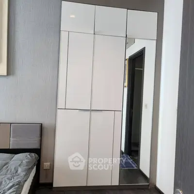 Modern bedroom with sleek wardrobe and stylish decor