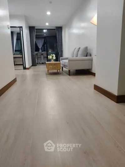 Spacious modern living room with elegant decor and large windows for natural light.