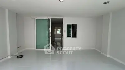 Spacious modern interior with sleek glass door and minimalist design