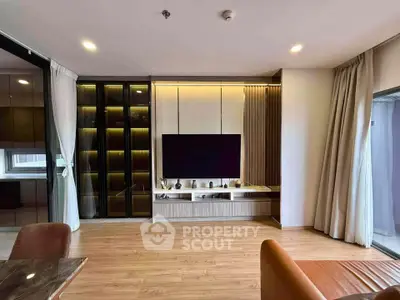 Modern living room with sleek TV unit and wooden flooring in a stylish apartment.