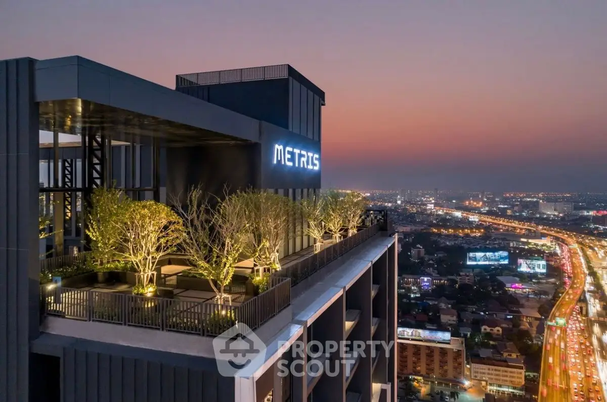 Stunning rooftop view of modern building with city skyline at sunset, featuring lush greenery and elegant design.