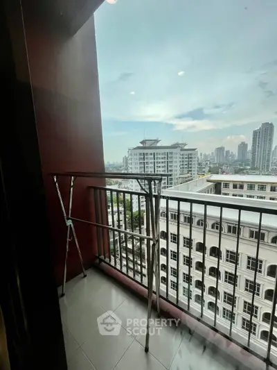 Charming balcony with cityscape view in modern high-rise apartment