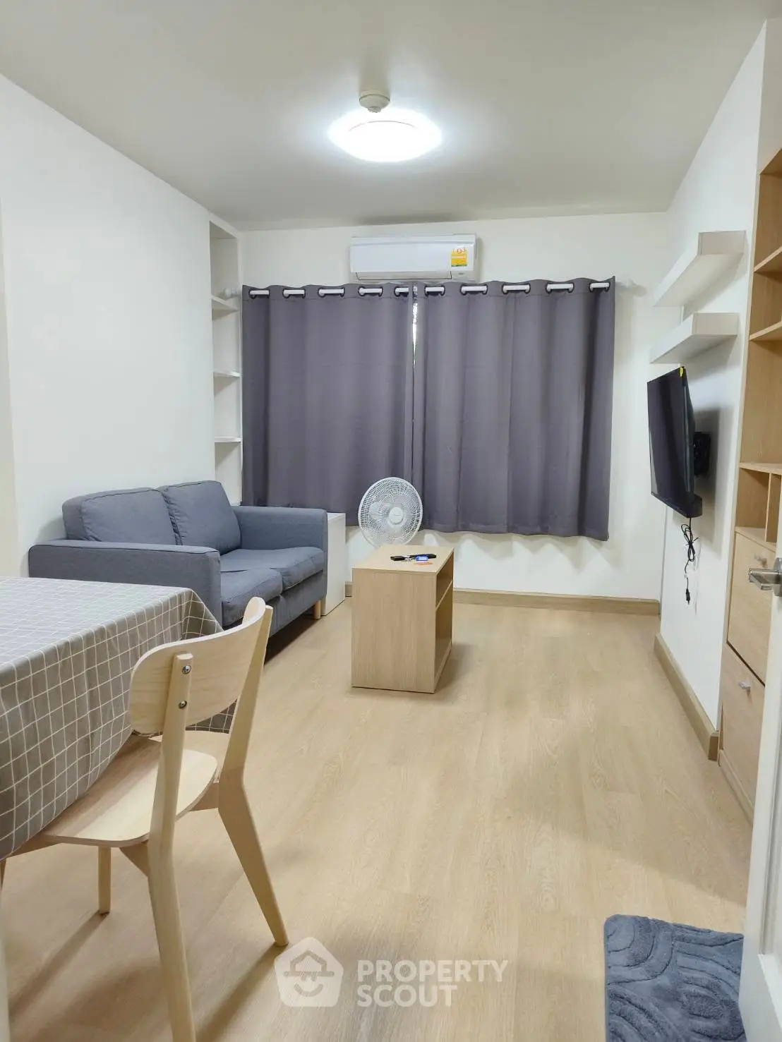 Cozy living room with modern furniture and natural light, perfect for relaxation and entertainment.