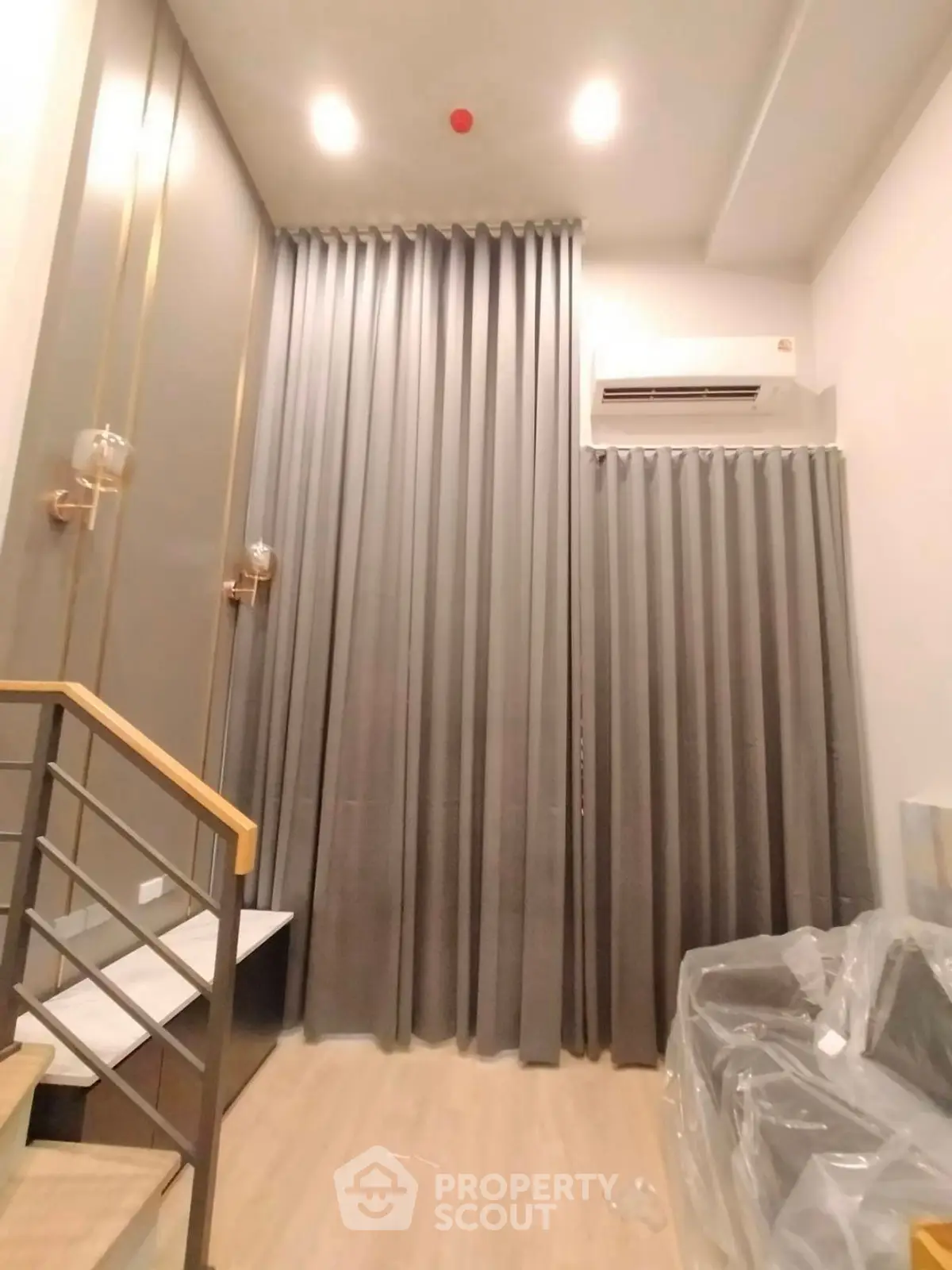 Modern interior with high ceilings and elegant curtains in a stylish living space.