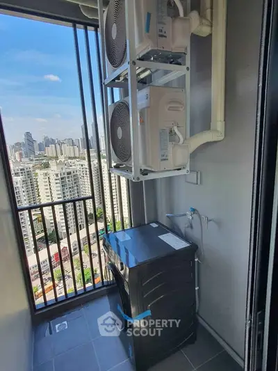 High-rise apartment balcony with city view and modern appliances, perfect for urban living.