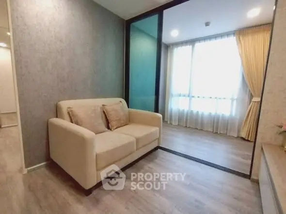 Modern living room with cozy sofa and large window with curtains