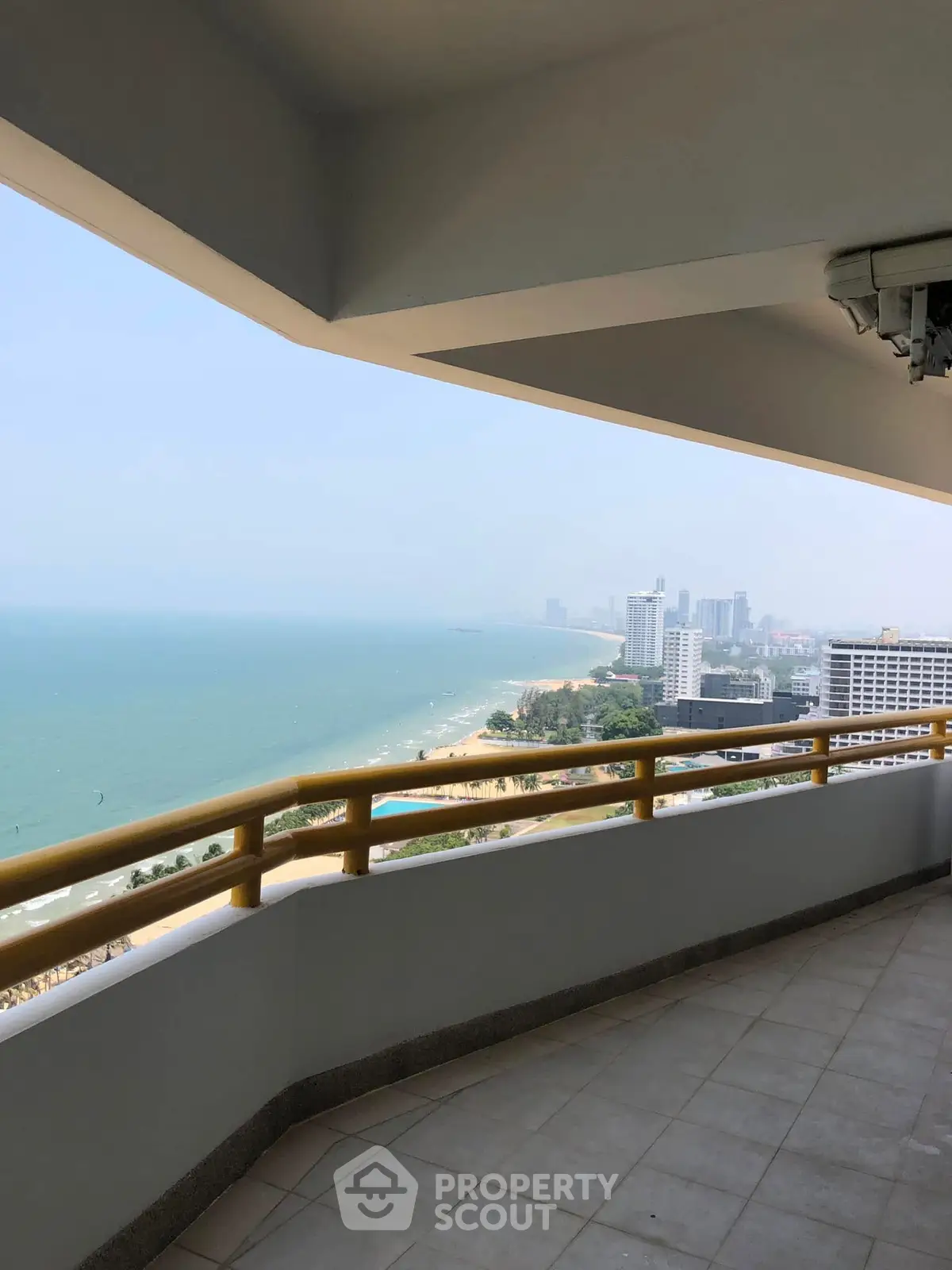 Stunning ocean view from a spacious balcony in a high-rise building.
