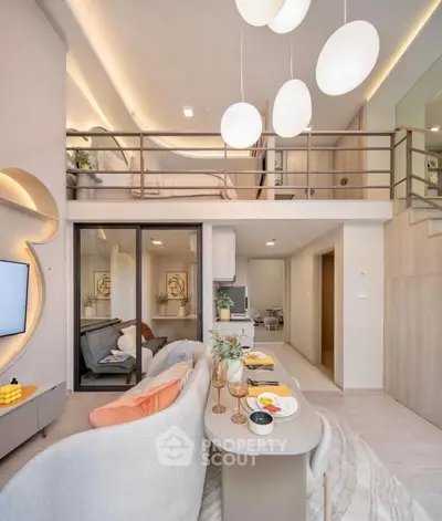 Modern open-plan living room with mezzanine bedroom, stylish decor, and elegant lighting.
