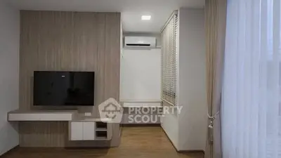 Modern living room with wall-mounted TV and air conditioning unit