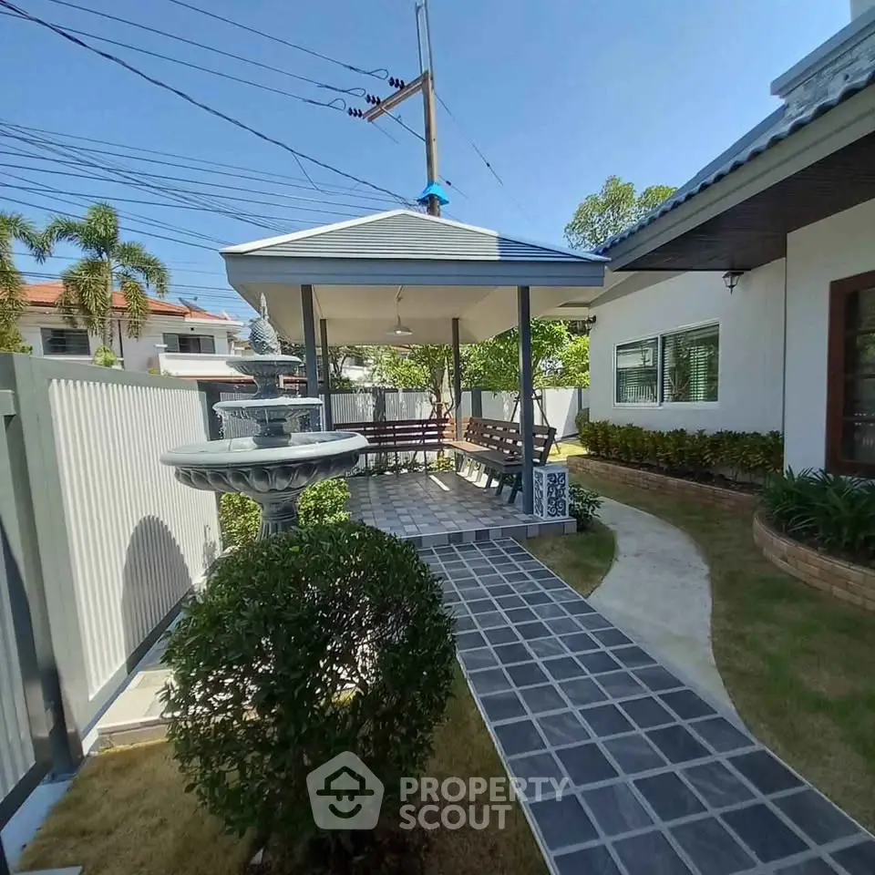 Charming outdoor garden with gazebo and fountain in a residential property, perfect for relaxation and entertaining.