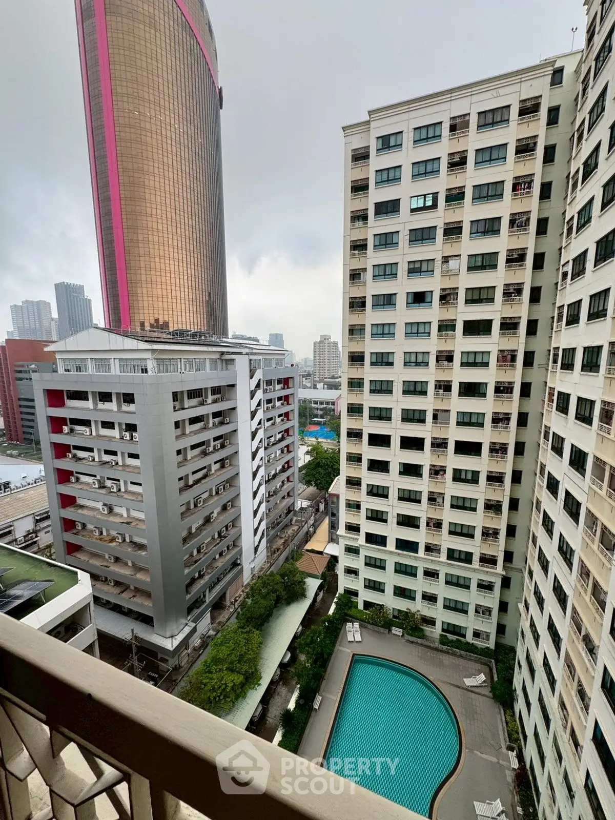 High-rise apartment view with pool and cityscape, perfect urban living in a vibrant neighborhood.