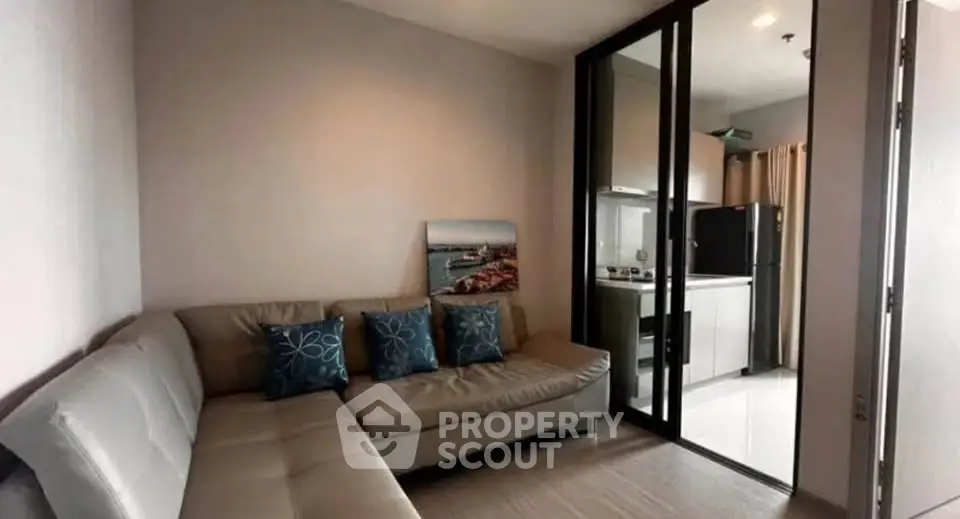 Modern living room with sleek sofa and open kitchen layout in stylish apartment