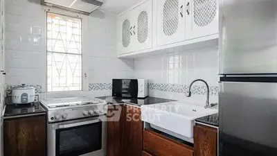 Charming kitchen with modern appliances and farmhouse sink in cozy home.