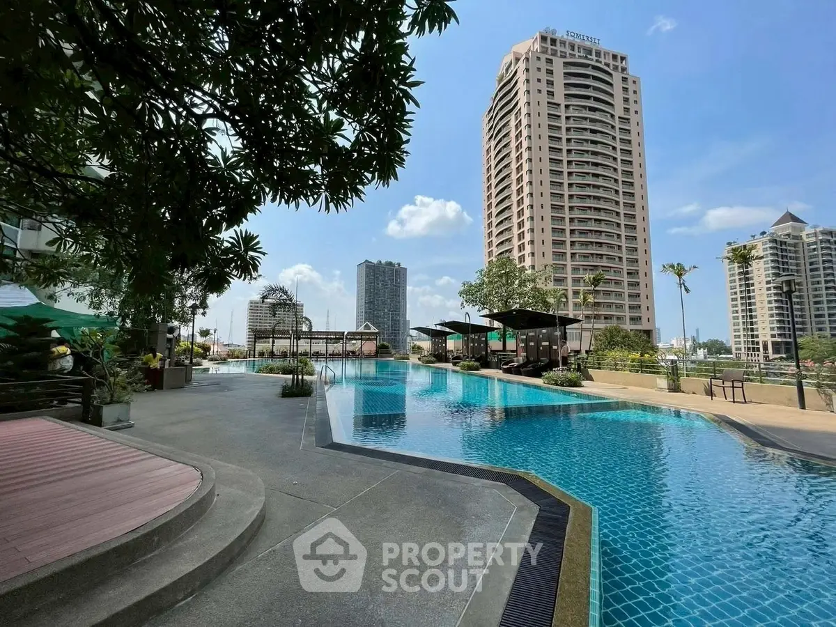 Luxurious high-rise building with stunning poolside view and modern amenities.