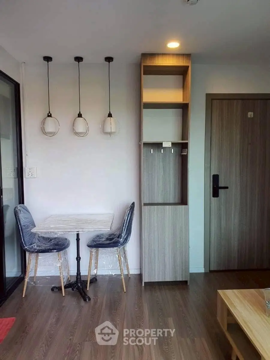 Modern apartment interior with stylish dining area and contemporary lighting.