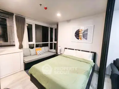 Modern bedroom with stylish decor and large windows for natural light.