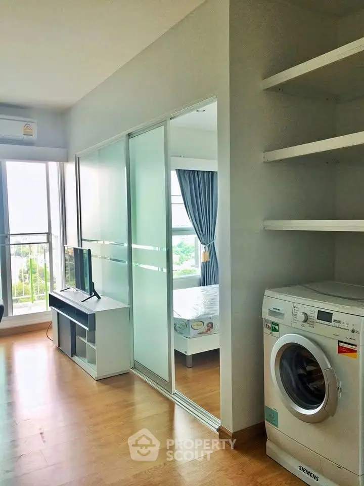 Modern apartment interior with washing machine and spacious living area