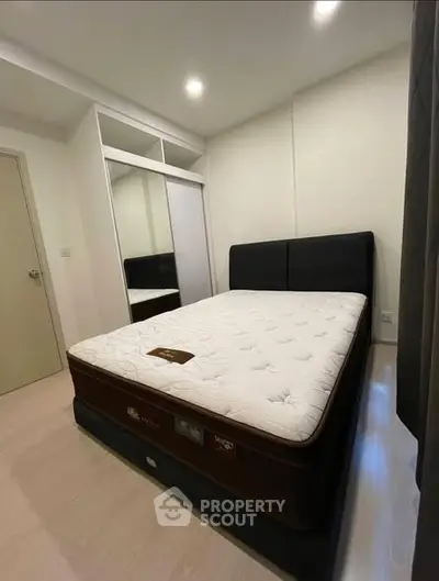 Modern bedroom with sleek design and comfortable mattress in a stylish apartment.