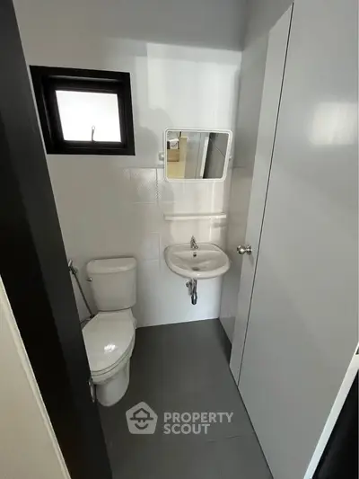 Compact modern bathroom with sleek fixtures and minimalist design