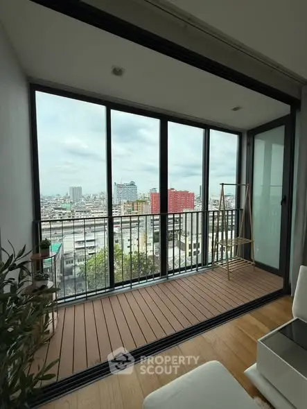 Modern apartment balcony with stunning city view and wooden flooring
