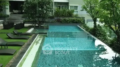 Luxurious outdoor pool area with lush greenery and modern design