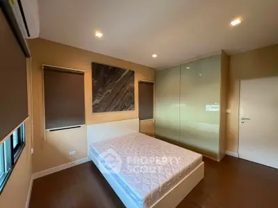 Spacious bedroom with modern design, featuring a large bed and built-in wardrobe, perfect for comfort and style.