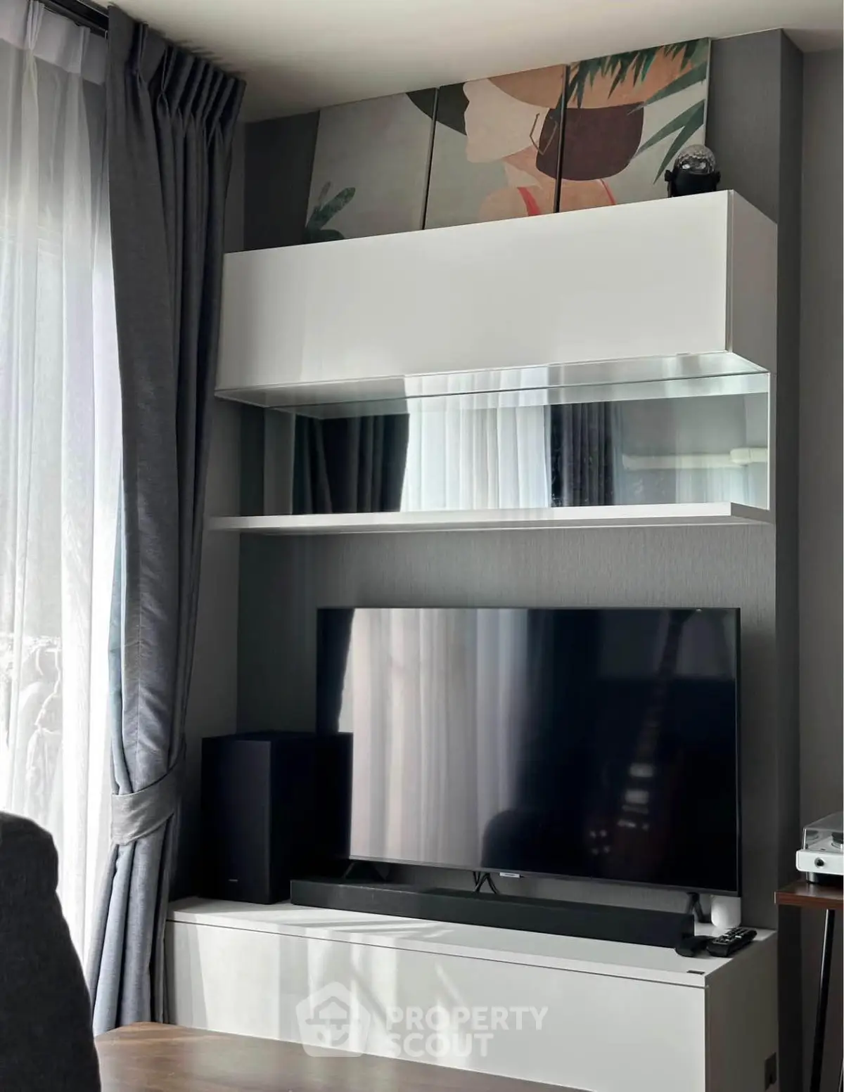 Modern living room with sleek TV setup and stylish shelving unit