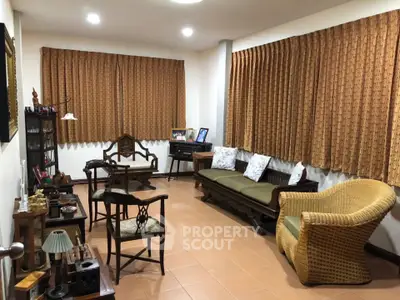 Charming living room with vintage furniture and warm lighting, perfect for cozy gatherings.