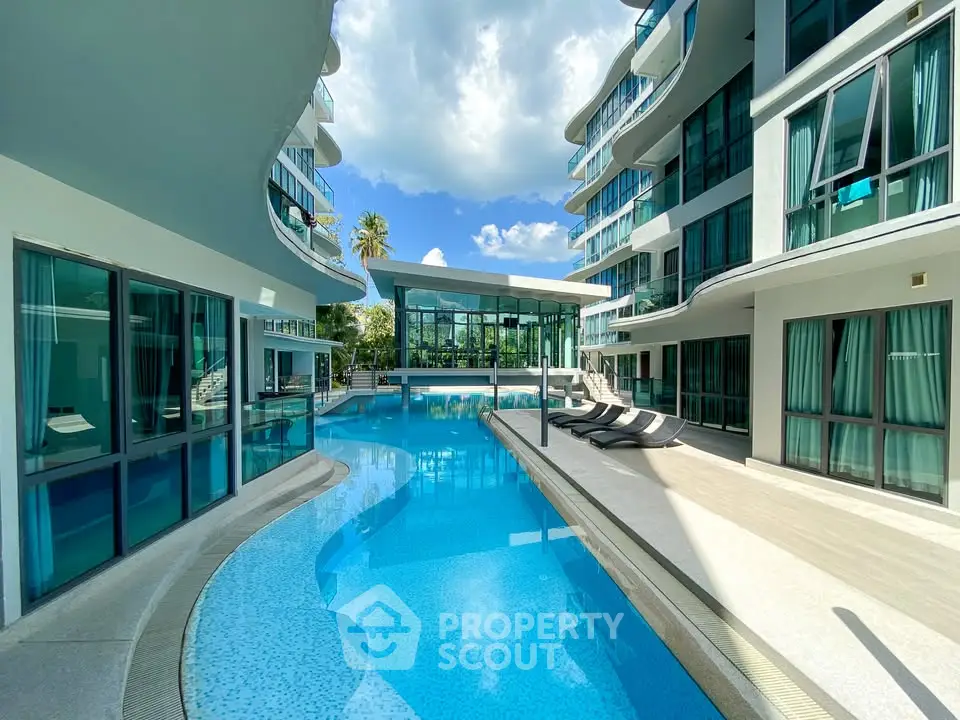 Luxurious modern apartment complex with stunning pool and sleek architecture.