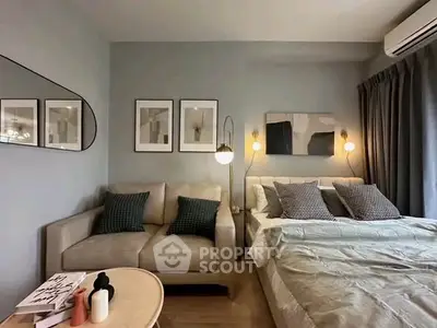 Stylish bedroom with cozy seating area and modern decor, perfect for relaxation and comfort.