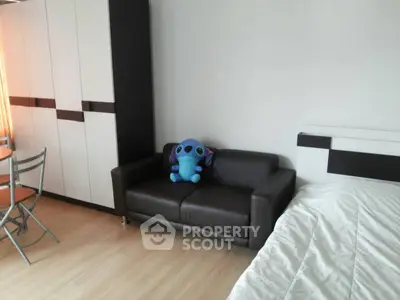 Modern bedroom with stylish furniture and plush toy accent