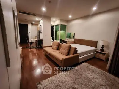 Spacious modern bedroom with cozy seating area and elegant decor