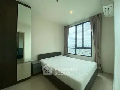 Modern bedroom with large window and city view, featuring minimalist design and natural light.