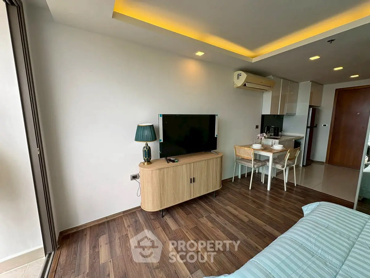 Modern living room with wooden flooring and stylish furniture in a cozy apartment.