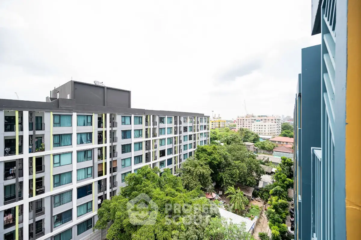 Modern urban apartment building with lush greenery and cityscape view.