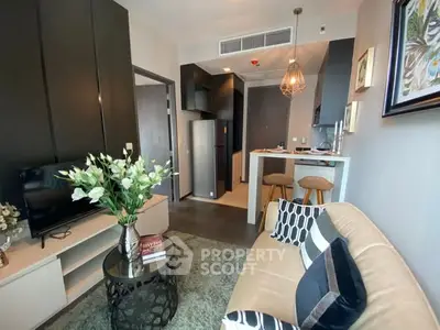 Modern living room with stylish decor and open kitchen layout in a cozy apartment.