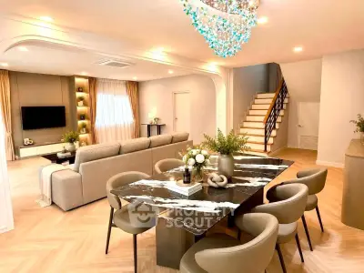 Luxurious open-plan living and dining area with elegant decor and modern lighting.