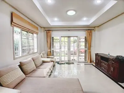 Spacious living room with large windows and elegant decor