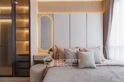 Modern bedroom with elegant lighting and stylish decor, featuring a cozy bed and sleek storage solutions.
