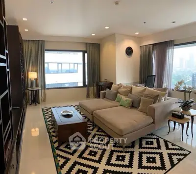 Spacious modern living room with large windows and stylish decor in urban apartment.